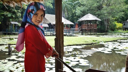 Portrait of young girl wearing traditional dress 'baju kurung' with hijab. Selected focus. Image...