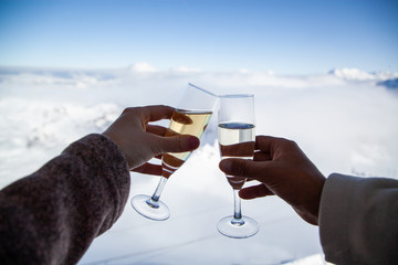 couple drinking champagne and snowy mountains winter holiday