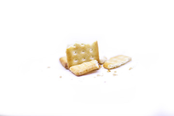 Biscuits crumbles into pieces close-up isolated on a white background