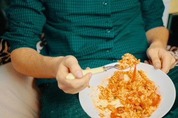 Man eats. Human eats pasta on a Sunny day.