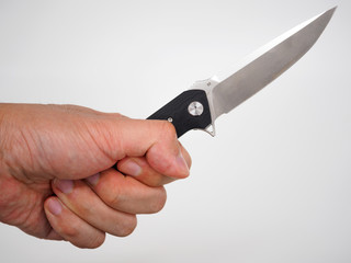 Hand holding a pocket-knife isolated on white background
