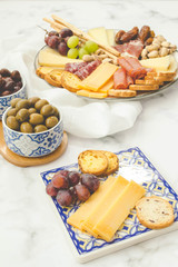 Cheese board brunch with pistachios, olives and grapes