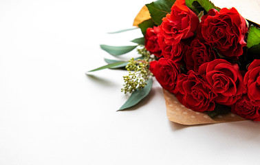 Red roses with eucalyptus on white background