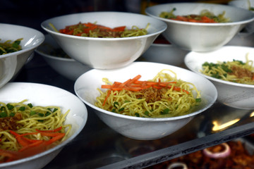 Prepared bowls of noodle soup on display