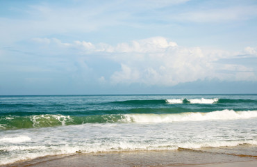 Waves, surf, and the blue sky over the sea, Karon sandy beach on a sunny day, Thailand
