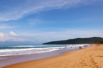 Waves, surf, and the blue sky over the sea, Karon sandy beach on a sunny day, Thailand