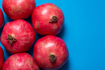 Group of red garnets on blue background, copy space
