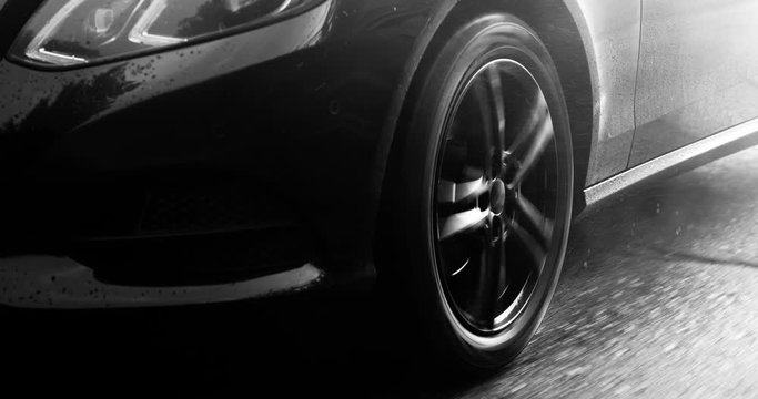 Reflecting everything around with its glossy surface, the premium car rides asphalt road where you can observe the suspension and how the tires perceive driving conditions. Black and white color gradi