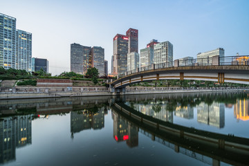 Naklejka premium Business district office buildings and water reflection in Beijing at night