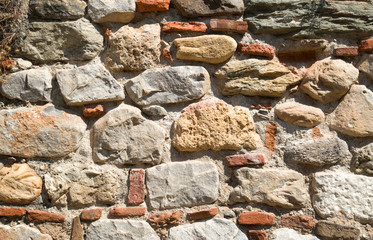 Colorful ancient stone wall close up