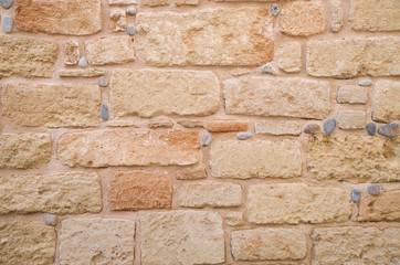 Colorful ancient stone wall close up