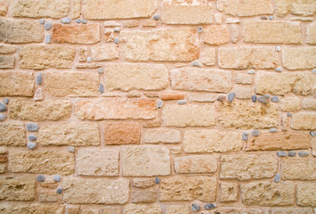 Colorful ancient stone wall close up