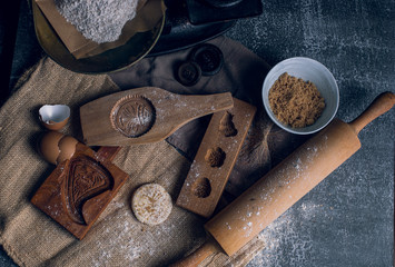 Fototapeta na wymiar Rustic wooden cookie molds in baking scene