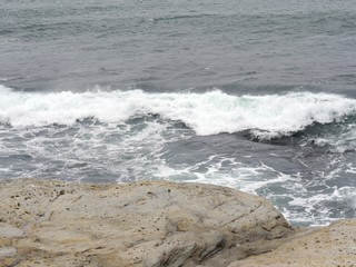 Waves breaking up on the rocks of a coastal area.