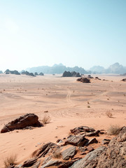 Tyre tracks in the desert of Wadi Rum with mountains in the background