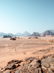 Fototapeta na wymiar Tyre tracks in the desert of Wadi Rum with mountains in the background
