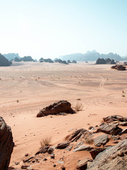 Tyre tracks in the desert of Wadi Rum with mountains in the background