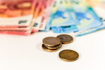 Close up money euro banknotes and coins on white background.