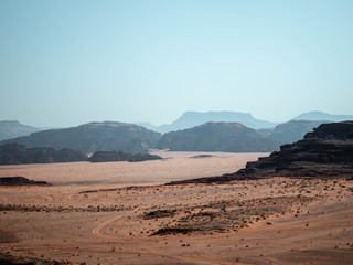 Mountains in the distance of the desert of Wadi Rum from a rocky outcrop