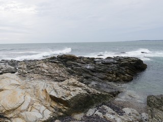 Limestone rocks extending into the water of a coastal area