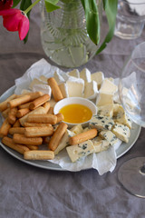 closeup plate of cheese and breadsticks