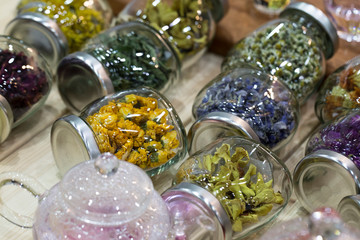 different healing herbs in glass bottles, flowers tea