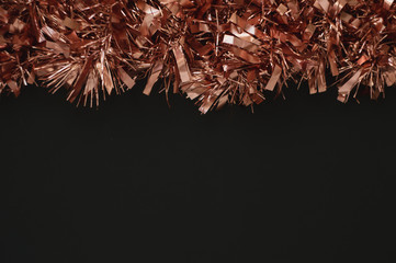 Christmas background with black space for text. Decor with rose gold garland. Wallpaper for the New Year 2020.