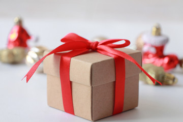 Gift box with red ribbon on white background.Christmas ornament.