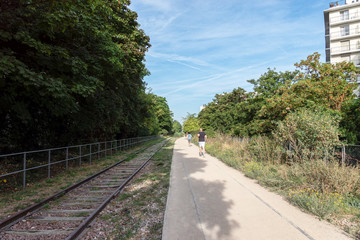 Paris, France: People running on the old railways ring of the Petite Ceinture, transformed as a...