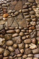 Stone wall of cobblestones covered with varnish