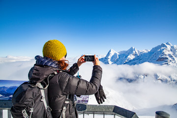 woman traveler in Swiss alps Jungfrau region taking pictures