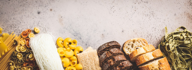 Various pasta background. Bread and different pasta on gray-blue background, copy space, top view.