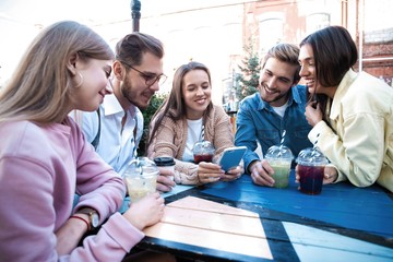 Group Of Friends Drinking Cocktails At Outdoor Bar
