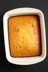 Homemade sweet Cornbread Ready to Eat on a black surface, top view. Flat lay, overhead, from above. Close-up.