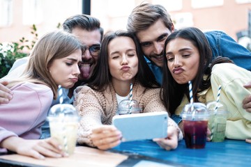 Group Of Friends Drinking Cocktails At Outdoor Bar