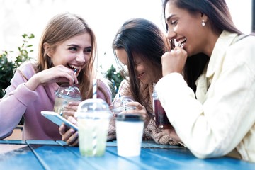 Group Of Friends Drinking Cocktails At Outdoor Bar