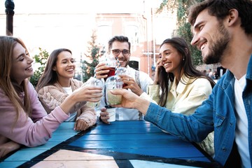 Group Of Friends Drinking Cocktails At Outdoor Bar