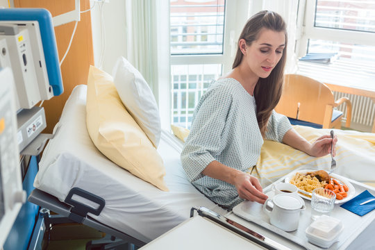 Patient In Hospital Lying In Bed Eating Meal