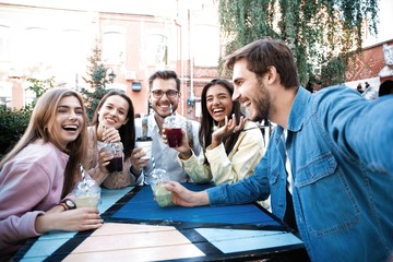 Group Of Friends Drinking Cocktails At Outdoor Bar