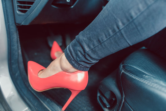 Woman Driving A Car In An Unsafe Manner With High-heel Shoes