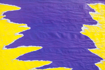 Yellow and purple old crumpled, torn and peeling paper placards texture background. Can be used for...
