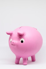 ceramic piggy bank or clay shaped like a pink pig