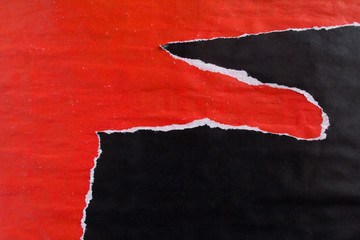 Red and black old crumpled, ripped and peeling paper posters with traces of glue texture background.