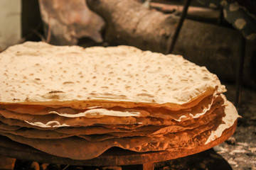 Making of pita bread in wood fire.