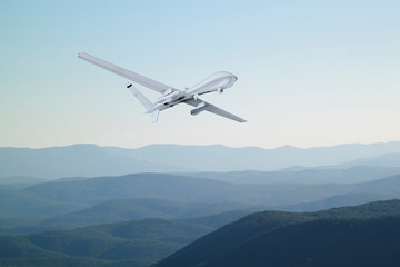 Fototapeta na wymiar Spy unmanned aerial vehicle (UAV) flies over low mountains in mist