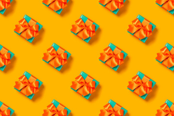 Pattern with stylish gift on a trendy orange background. Present for St. Valentine's day, engagements, Mother's Day, birthday, New Year, Christmas, holidays