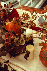 Stylish thanksgiving autumn table decor with pumpkin and dried branches