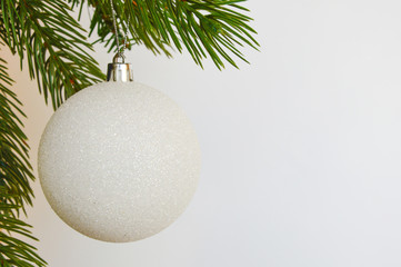 Decor for a happy Christmas and New year. Silver color. Christmas tree balloon on white background. happy winter holidays. Background for congratulations. White balls for Christmas tree decoration. An