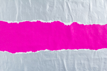 Purple and silver grey crumpled, torn and peeling gloss paper posters glued on rough surface...