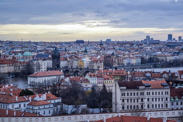 Fototapeta na wymiar Aerial view of cityscape of old town of Prague, with a lot of rooftops, churches, and the landmarks.